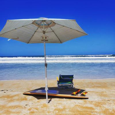 Umbrella, beach char, surf board - things to bring for a day at Daytona Beach