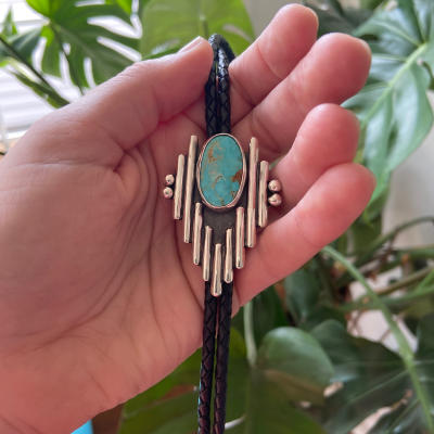 A turquoise bolo tie made by Jocelyn Morin Metalsmith