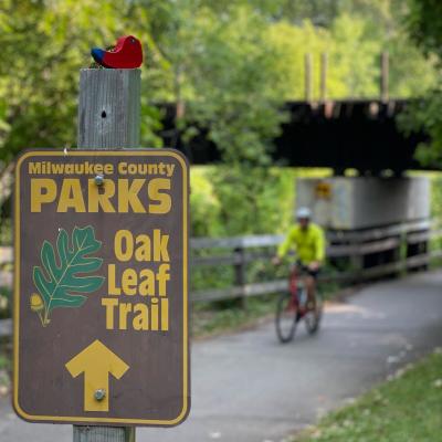 A little whimsy goes a long way. From its permanent perch along Underwood Creek this little red birdie tweets your approach to Bluemound Road.