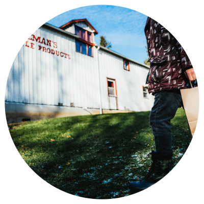 Visitor strolling toward Jakeman's Maple Syrup shop