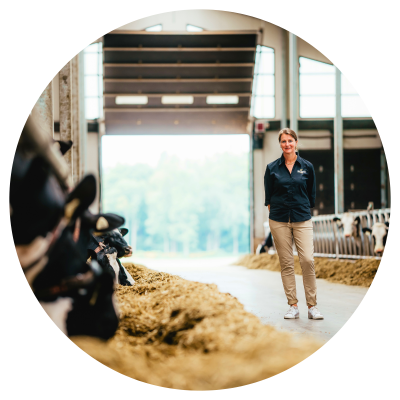 woman in barn on tour showing cows