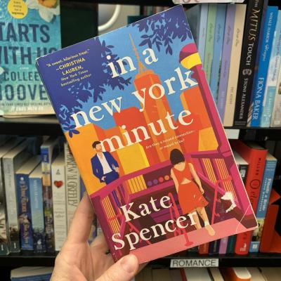 someone holding a book titled in a new york minute