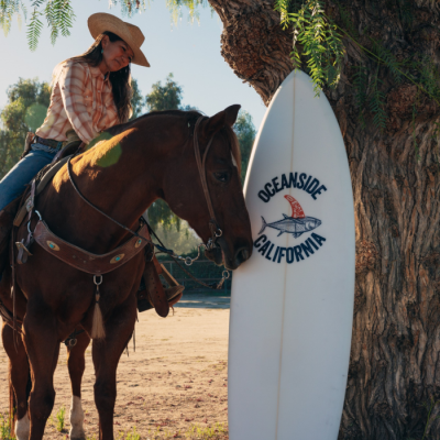 Horse and Rider next to Oceanside Surfboard