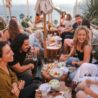 Friends dining rooftop in Oceanside