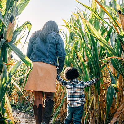 Corn maze mom and son walking backs 400x400