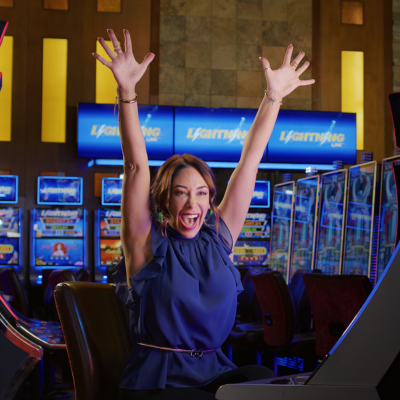 A lady winning at a slot machine