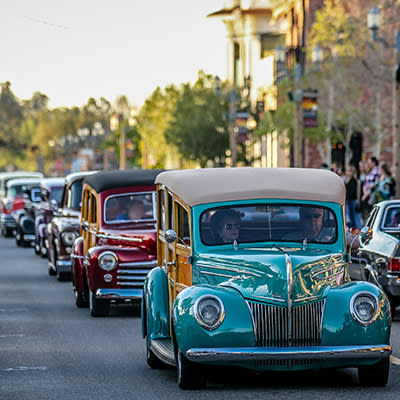 Classic cars cruising street