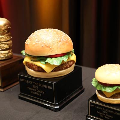 Several trophies shaped like hamburgers of assorted sizes, on display