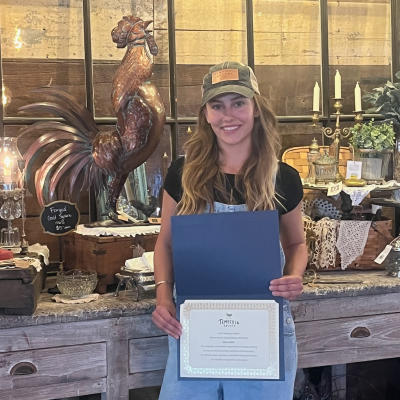 Woman holding an award certificate