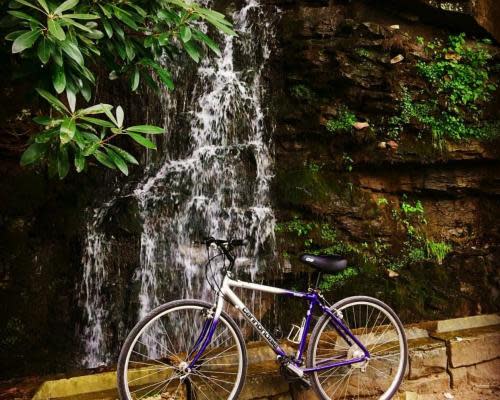 Connellsville | a bike in front of a waterfall