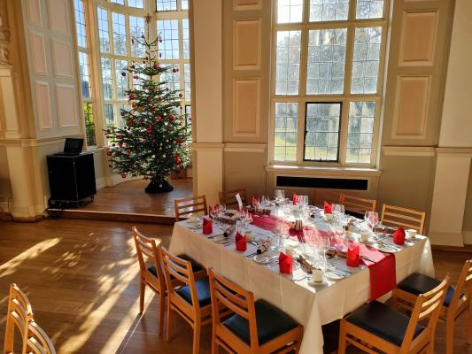 Newnham College dining hall decorated and set up for an office Christmas lunch