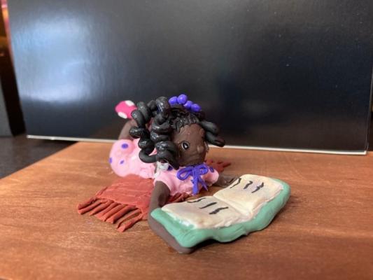 Clay Art of Girl Reading at Charlie's Place