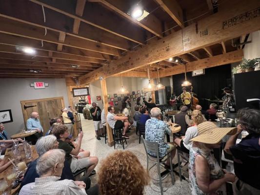 Group watching a jazz band perform on stage