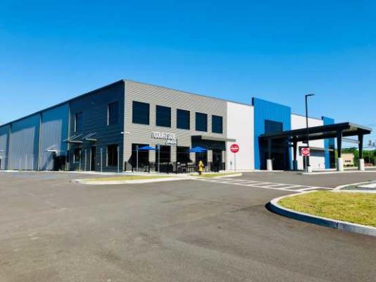 Impact Athletic Center exterior shot under a bright blue sky