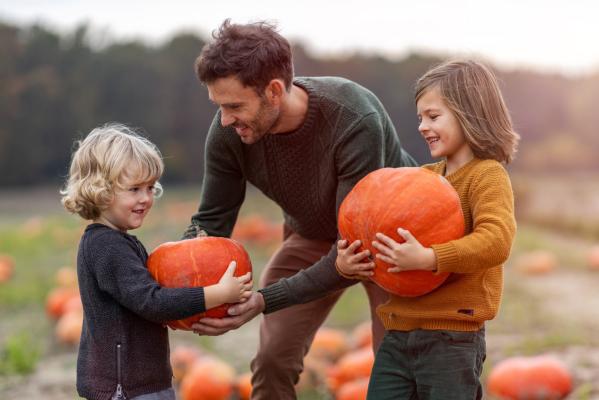 Family picking pumpkins at Fair Oaks Farms