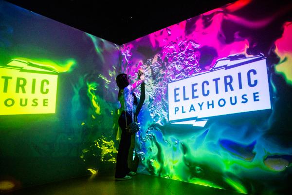A woman touches a wall at Electric Playhouse