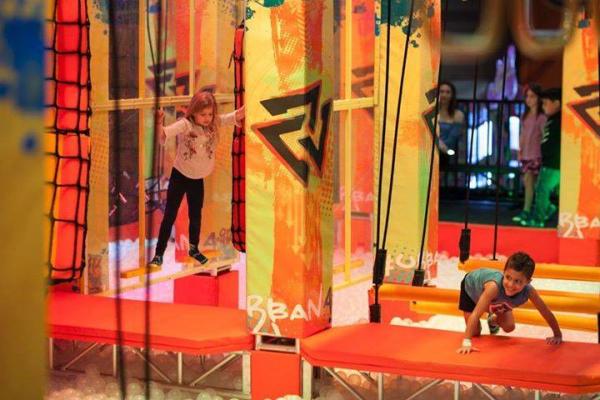 Two kids explore the Warrior Course at Urban Air