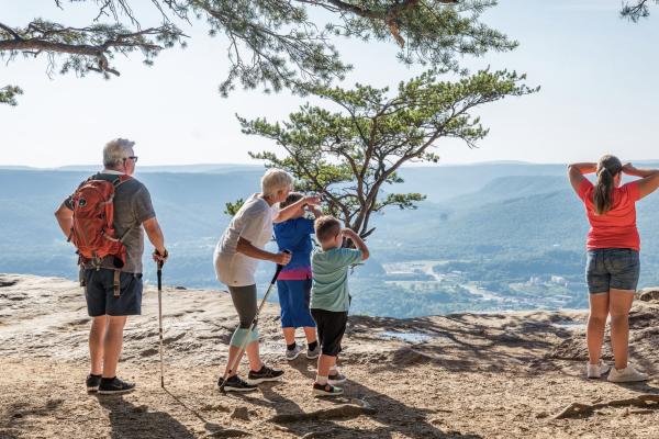 family with grandparents and kids look out at the views from Sunset Rock on Lookout Mountain