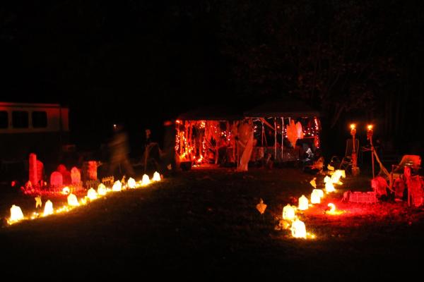 Halloween decorated campsite at Charlestown State Park glows with orange and red lights, ghosts, skeletons and tombstones during a camping trick or treat event.