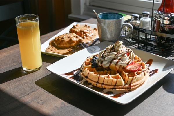 El Mananero Breakfast table with waffle and biscuits and gravy