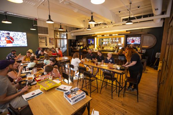 Guests enjoying food, drinks and games at Simon's Bar in Budd Dairy Food Hall