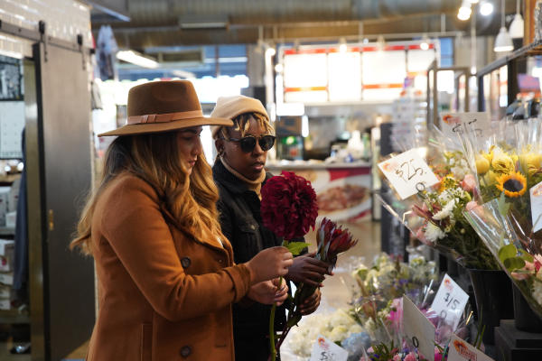 Two people shop for flowers at the North Market