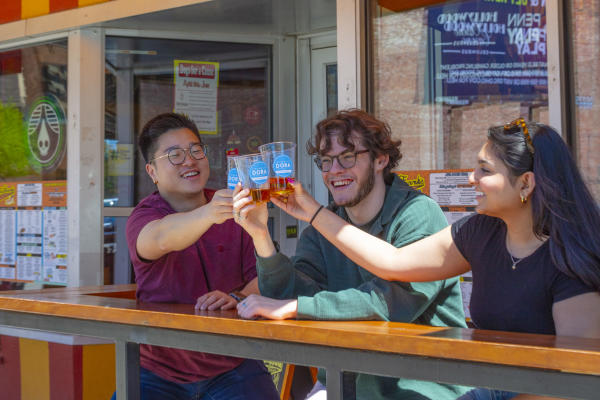 Three people clinking DORA cups