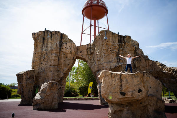 Girl sits atop the Scioto Audubon Climbing Wall.