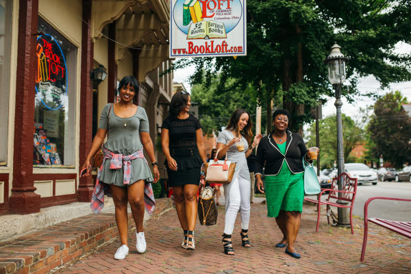 Four women walking in front of Book Loft in German Village