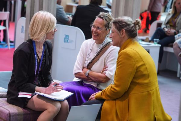Three women networking at IMEX America