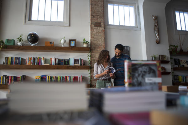 Man and woman reading a book in Two Dollar Radio Headquarters, an independent bookstore