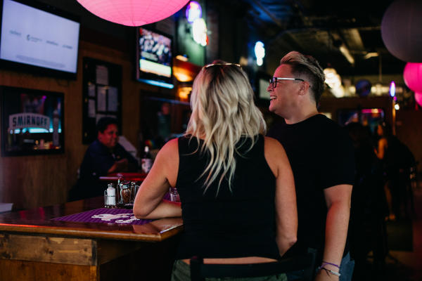 Two women standing at the bar inside Slammers.
