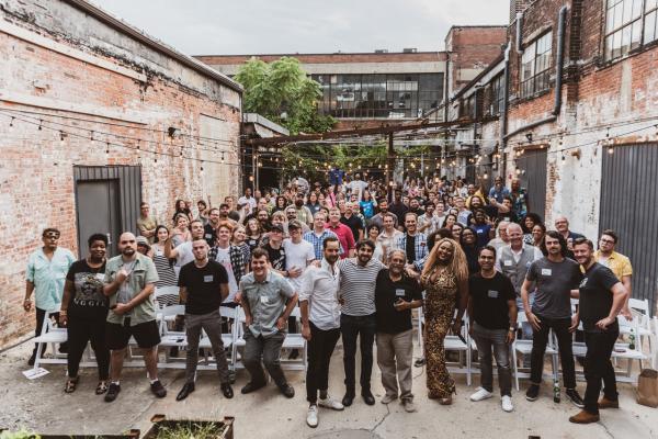 Large group of local musicians and attendees in Strongwater's outdoor courtyard at the Columbus Music Commission’s Music Business Mondays forum series