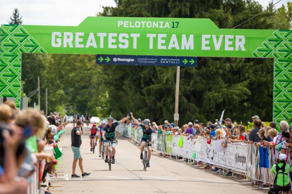 Two bike riders crossing the finish line during Pelotonia's Ride Weekend