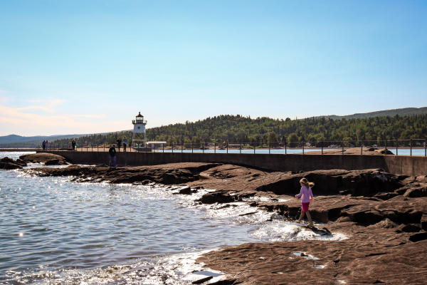 A little girl playing on the rocks in Grand Marais