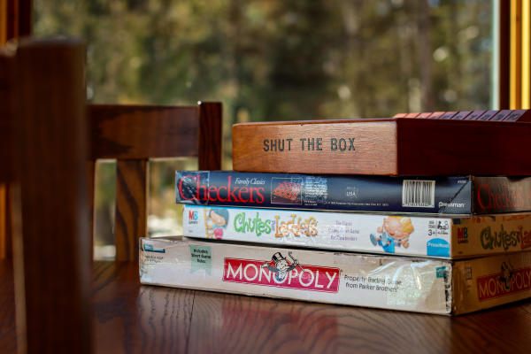 A stack of board games in a cabin