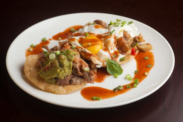 Breakfast tacos topped with an egg served at Griddle 145