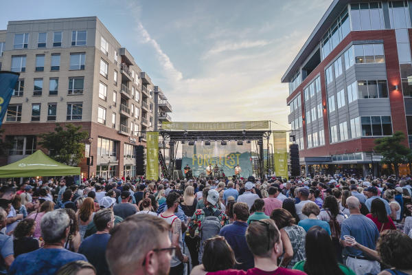 A crowd of people looking at the ForeFest stage in Bridge Park