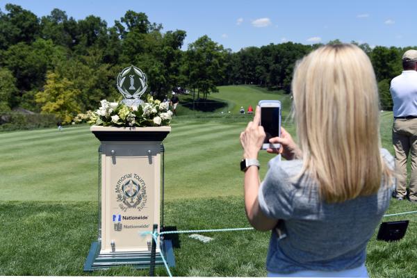 Girl taking a photo of the Memorial Tournament trophy while on course at Muirfield Village Golf Club