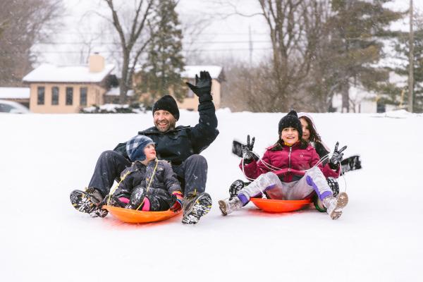 Sledding in Coffman Park Family