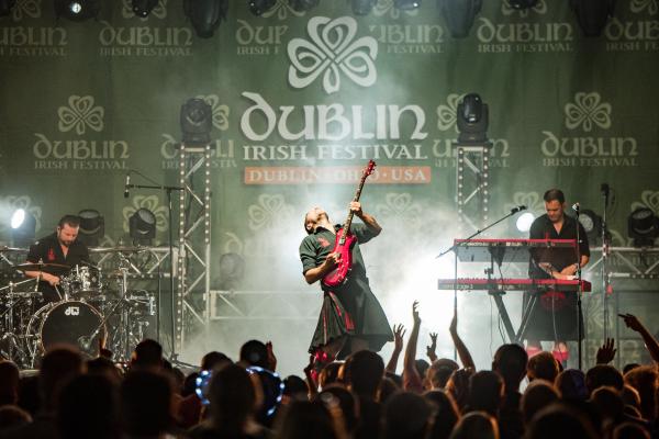 Guitarist from the Red Hot Chili Pipers performing on stage at the Dublin Irish Festival