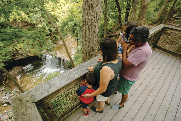 Family looking over the observation deck down to Indian Run waterfall