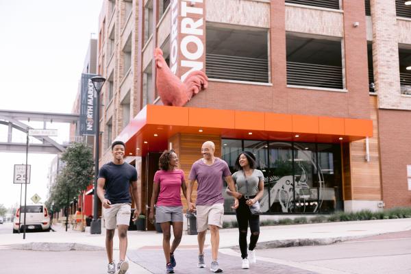 A family crossing the street in front of North Market Bridge Park