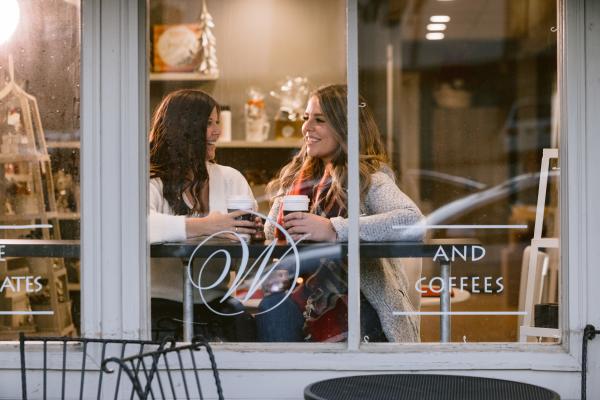 Two friends enjoying a cup of coffee in the window of Winans chocolate and coffees in Historic Dublin