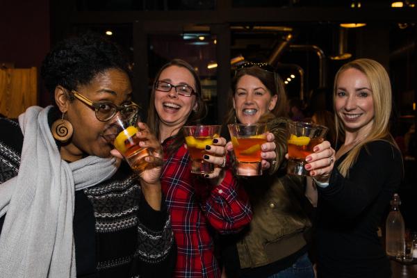 Four women cheersing cocktails