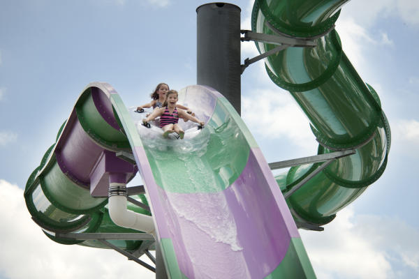Two young girls tubing down slide at Zoombezi Bay.