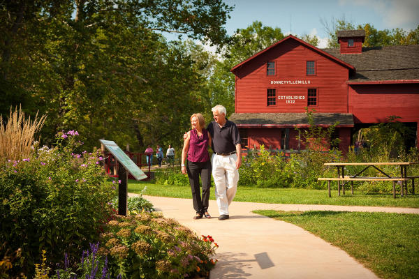 Visitors enjoy a walk along Elkhart County's Heritage Trail by Bonneyville Mill.