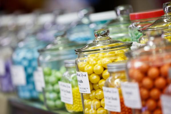 close-up of candy jars filled with yellow, green, blue and purple colored candies at Wakarusa Dime Store