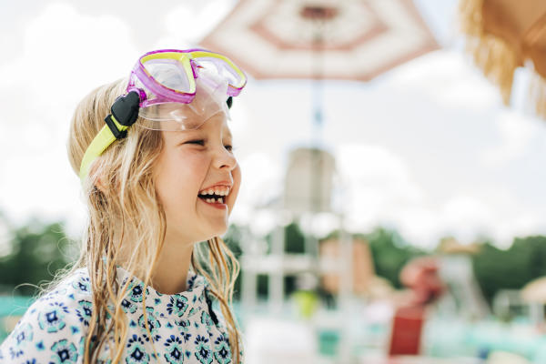 Young girl with googles enjoying a day at the pool