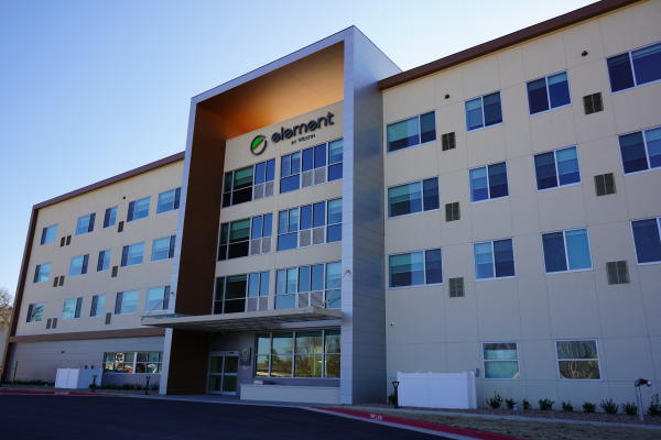An back-lit exterior shot of the Element by Westin hotel on a sunny day in Fort Smith, Arkansas.